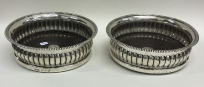 A good pair of Georgian half fluted silver wine co