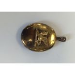 A silver gilt oval locket mounted with a sphinx wi
