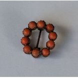 A Georgian circular coral brooch in claw mount. Ap