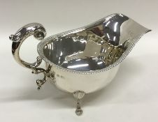 An Edwardian silver sauce boat with gadroon rim. B