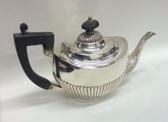 An Edwardian bachelor's half fluted silver teapot.