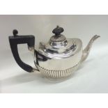 An Edwardian bachelor's half fluted silver teapot.