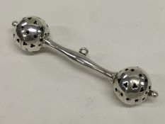 A small Edwardian silver rattle with pierced decor