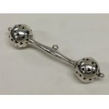 A small Edwardian silver rattle with pierced decor