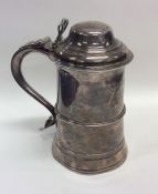 A good Georgian silver lidded tankard on tapering