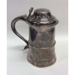 A good Georgian silver lidded tankard on tapering