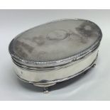 A silver hinged top jewellery box with engine turn