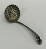 An Edwardian silver sifter spoon with gilt bowl. A