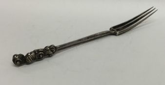 A Continental Antique three prong fork with scroll