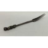 A Continental Antique three prong fork with scroll