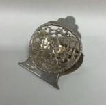 An unusual cast silver stationery clip decorated w