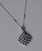 An attractive sapphire and diamond drop pendant wi