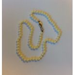 A string of pearl beads with 9 carat clasp. Approx