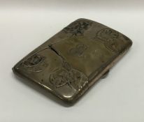 A heavy silver cigar case decorated with flowers.