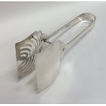 A pair of stylish silver cake tongs with pierced b