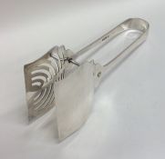 A pair of stylish silver cake tongs with pierced b