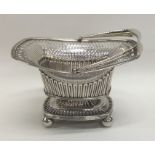 A Georgian silver swing handled sweet dish with fl