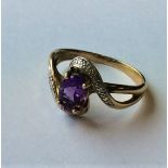 An amethyst and diamond crossover ring in 9 carat