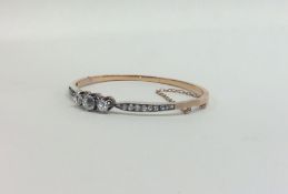 A good quality three stone diamond hinged bangle w