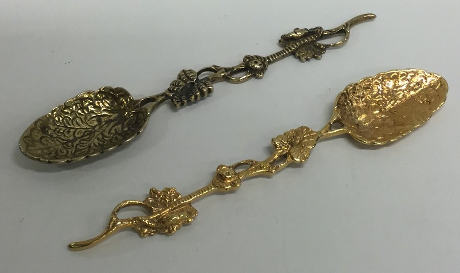 A pair of Antique silver gilt spoons decorated wit