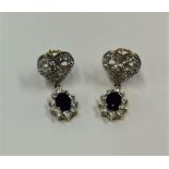 A pair of large sapphire and diamond oval cluster
