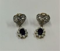 A pair of large sapphire and diamond oval cluster