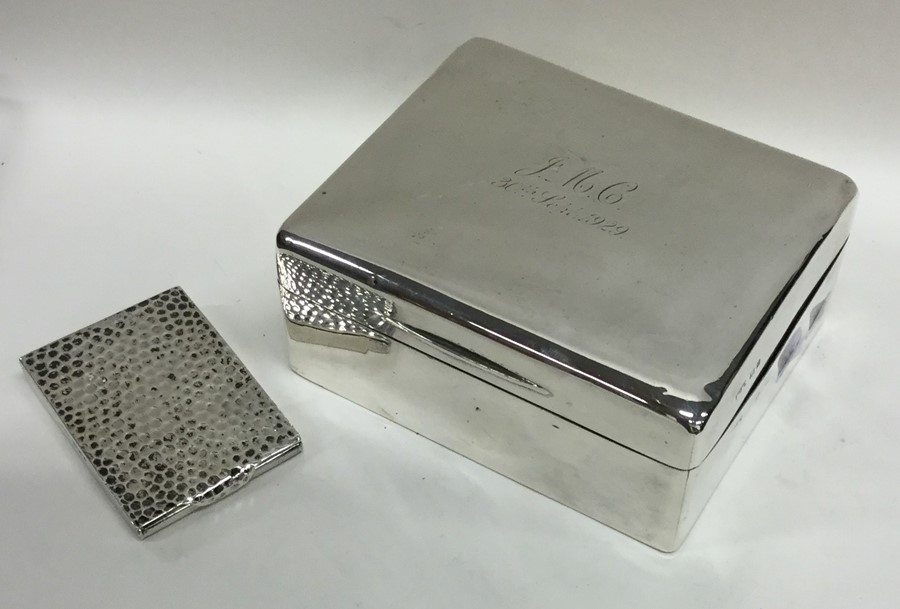 A heavy silver textured match case together with a