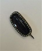 A Georgian pearl mounted mourning brooch with hair