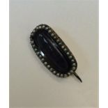 A Georgian pearl mounted mourning brooch with hair