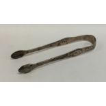 A good pair of bright cut silver sugar tongs decor