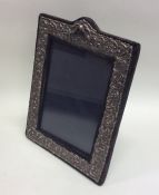 A modern silver embossed picture frame. Est. £30 -