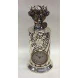 An unusual silver lamp mounted with a clock with s