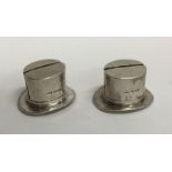 A pair of unusual silver menu holders in the form