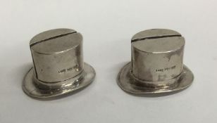 A pair of unusual silver menu holders in the form