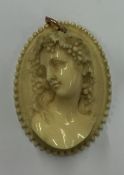 A large oval ivory cameo of a lady in high relief