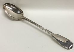 A fiddle and thread pattern silver basting spoon.