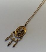 A small gold pendant on chain. Approx. 3.4 grams.