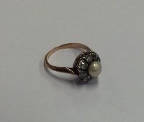 A natural pearl and diamond circular cluster ring