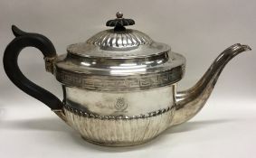 A Georgian silver half fluted teapot decorated wit