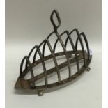 An unusual silver canoe shaped toast rack on brack