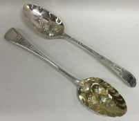 Two Georgian silver embossed berry spoons. Approx.