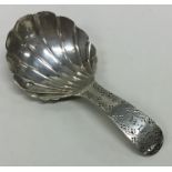 A Georgian silver caddy spoon with fluted bowl and