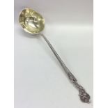 A massive German silver ladle with gilt bowl decor