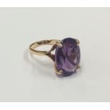 An 18 carat gold amethyst single stone ring in cla