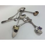 A bag containing silver and other cruet spoons, te