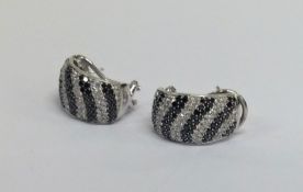 A pair of diamond and black diamond ear pendants i