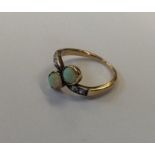 An opal and rose diamond two stone crossover ring.