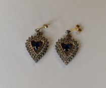 A pair of diamond and sapphire heart shaped earrin