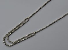 A rare French platinum two strand necklace attract