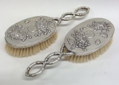 A pair of Chinese silver hair brushes with floral